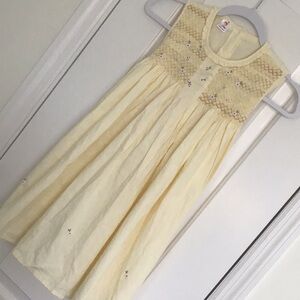 Smocked girl dress, featuring delicate embroidered floral details.